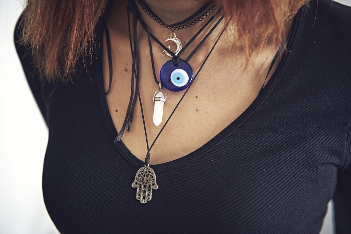 Lucky charms hanging from a neck Love Spells