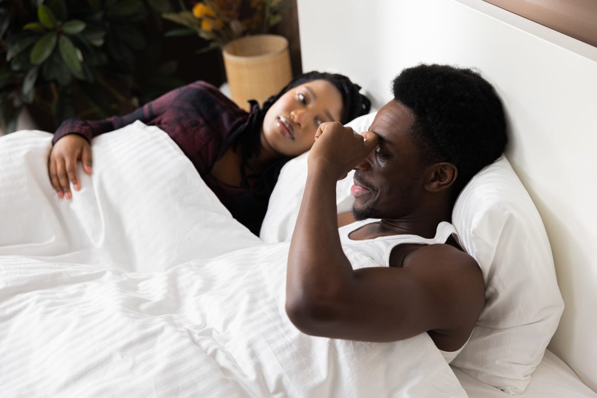 Cute happy delighted african american couple lying in bed in the morning, good morning happy time n bed at home Love Spells
